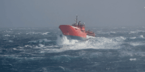 boat out at sea during a storm fighting against the waves